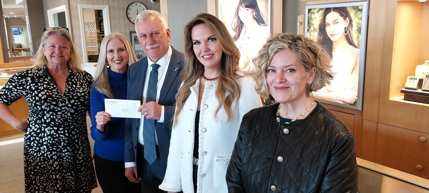John Rutkowski, manager of the Underwood Jewelers store in Ponte Vedra Beach, presents a check to the Ponte Vedra Woman&rsquo;s Club for $21,200 raised at the Nov. 20 trunk show. From left are Parker Alter, club vice president for ways and means; Anne Urban, club president; Rutkowski; Abby Broyles, fundraising coordinator; and Sarah Merkling, store assistant manager.