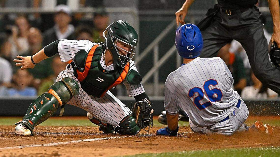 CORAL GABLES, FL - FEBRUARY 27: Miami catcher Alex Sosa (13) tags Florida outfielder Cash Strayer (26) out at home to end the eighth inning as the Miami Hurricanes faced the Florida Gators on February 27, 2026, at Mark Light Field at Alex Rodriguez Park in Coral Gables, Florida. (Photo by Samuel Lewis/Icon Sportswire via Getty Images)