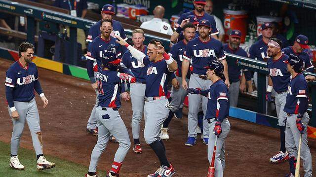 MIAMI, FLORIDA - MARCH 15: Gunnar Henderson #11 of Team United States celebrates with Aaron Judge #99 after hitting a solo home run against Team Dominican Republic during the fourth inning at loanDepot park on March 15, 2026 in Miami, Florida. (Photo by Megan Briggs/Getty Images)