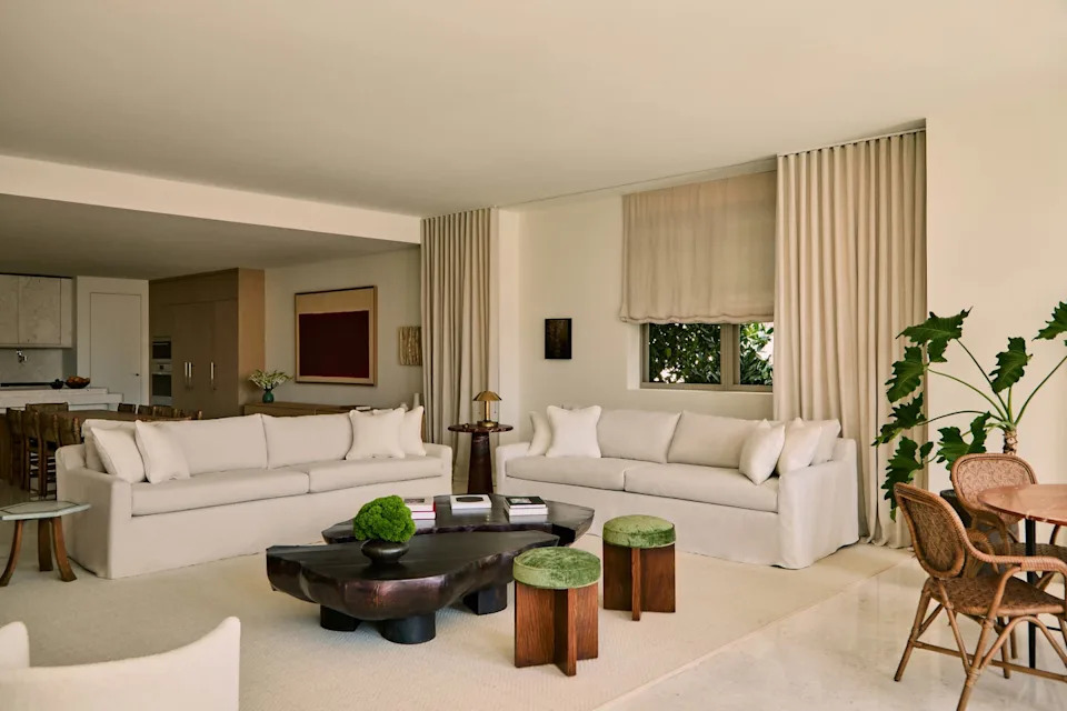 Modern living room with soft furnishings and natural elements.