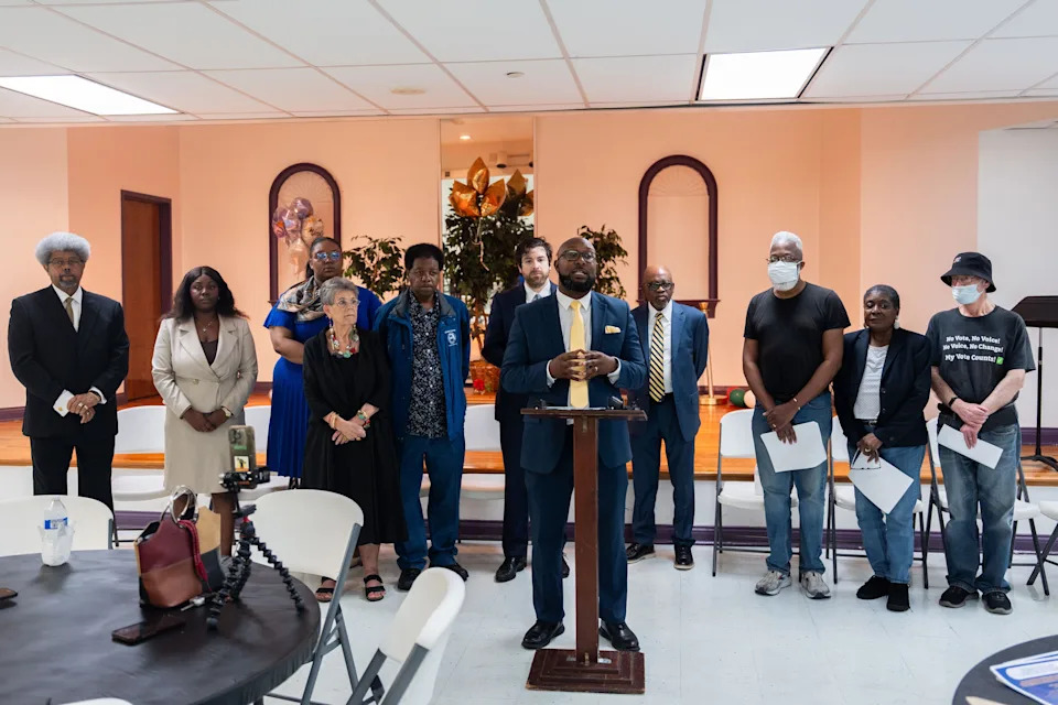 NAACP Tallahassee Branch President Marlon Williams-Clark speaks with a group of supporters behind him during a press conference voicing concerns of the sale of Tallahassee Memorial HealthCare to Florida State University, Thursday, March 5, 2026.