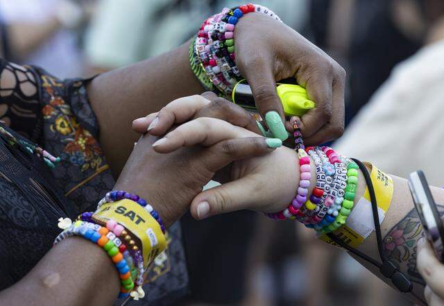People share kandi bracelets as they attend Ultra Music Festival’s 26th anniversary at Bayfront Park on Saturday, March 28, 2026, in downtown Miami, Fla.