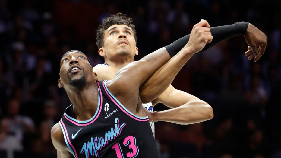 Miami Heat center Bam Adebayo (13) and Orlando Magic forward Tristan da Silva, right, wait for a rebound during the first half of an NBA basketball game in Miami, Saturday, March 14, 2026. (AP Photo/Rhona Wise)