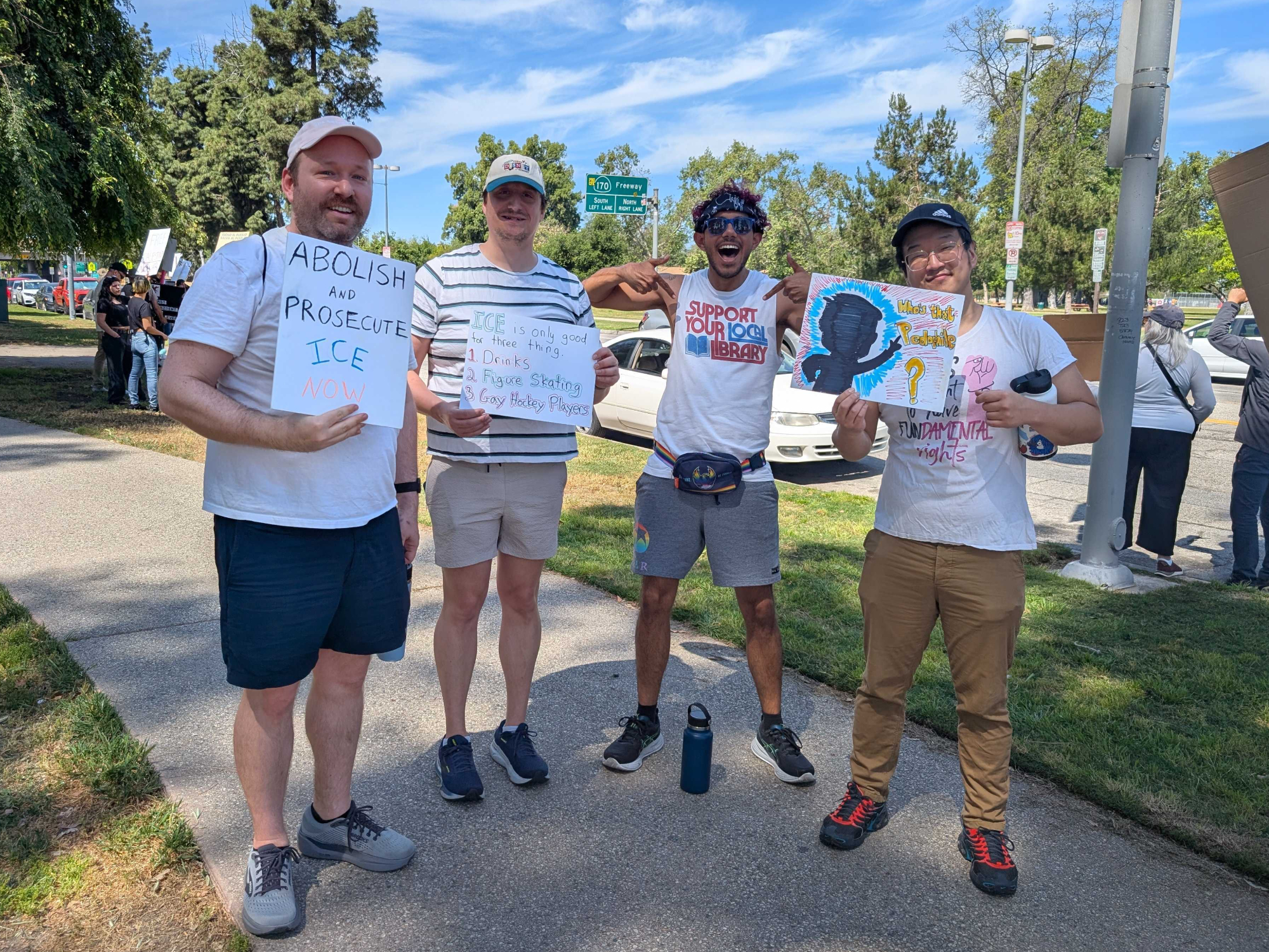 Four protestors stand and pose. 