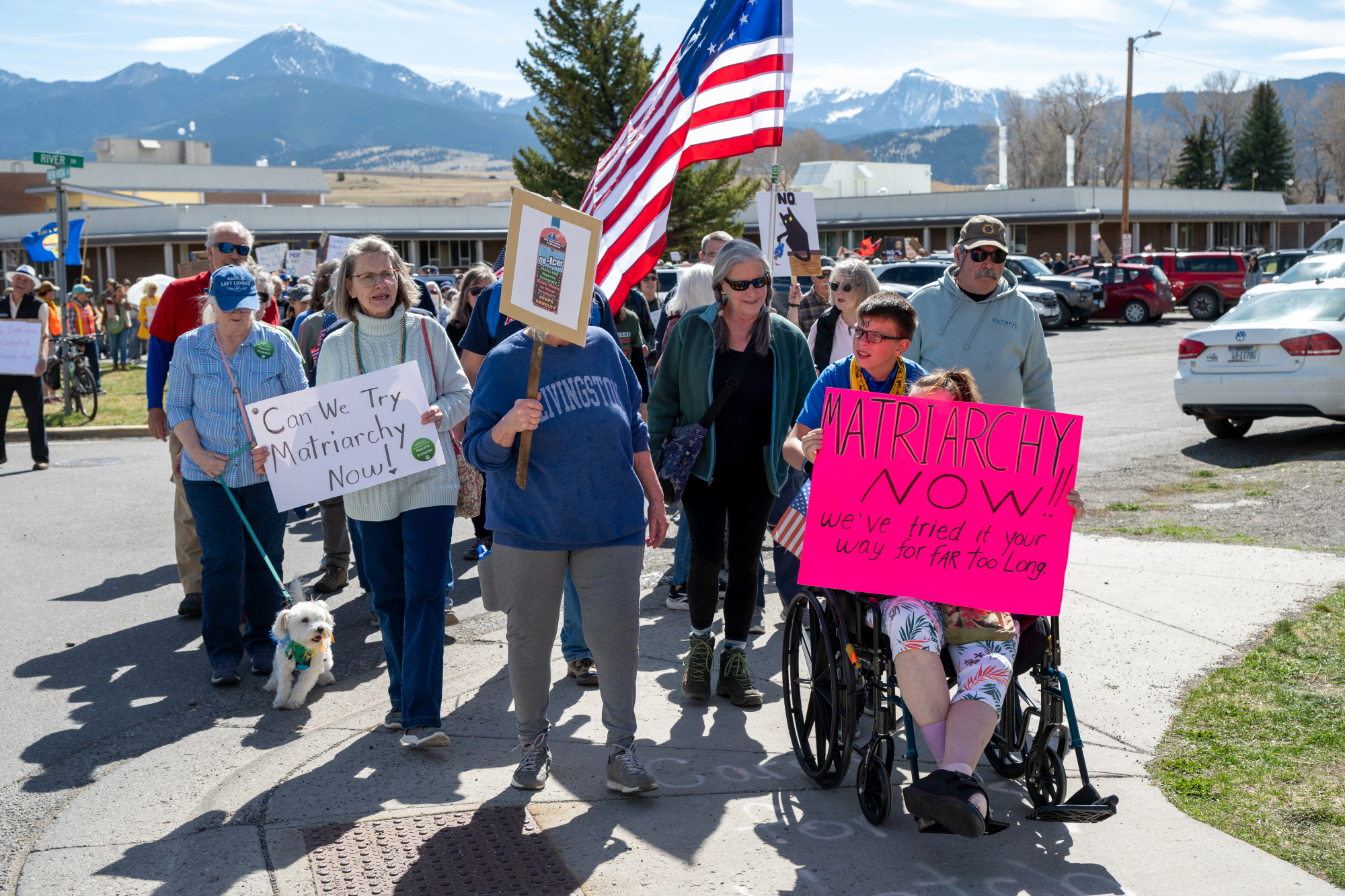 Women hold signs in favor of matriarchy. 