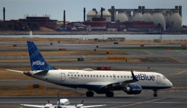 A JetBlue plane taxis on the Logan Airport runway in March 2025.