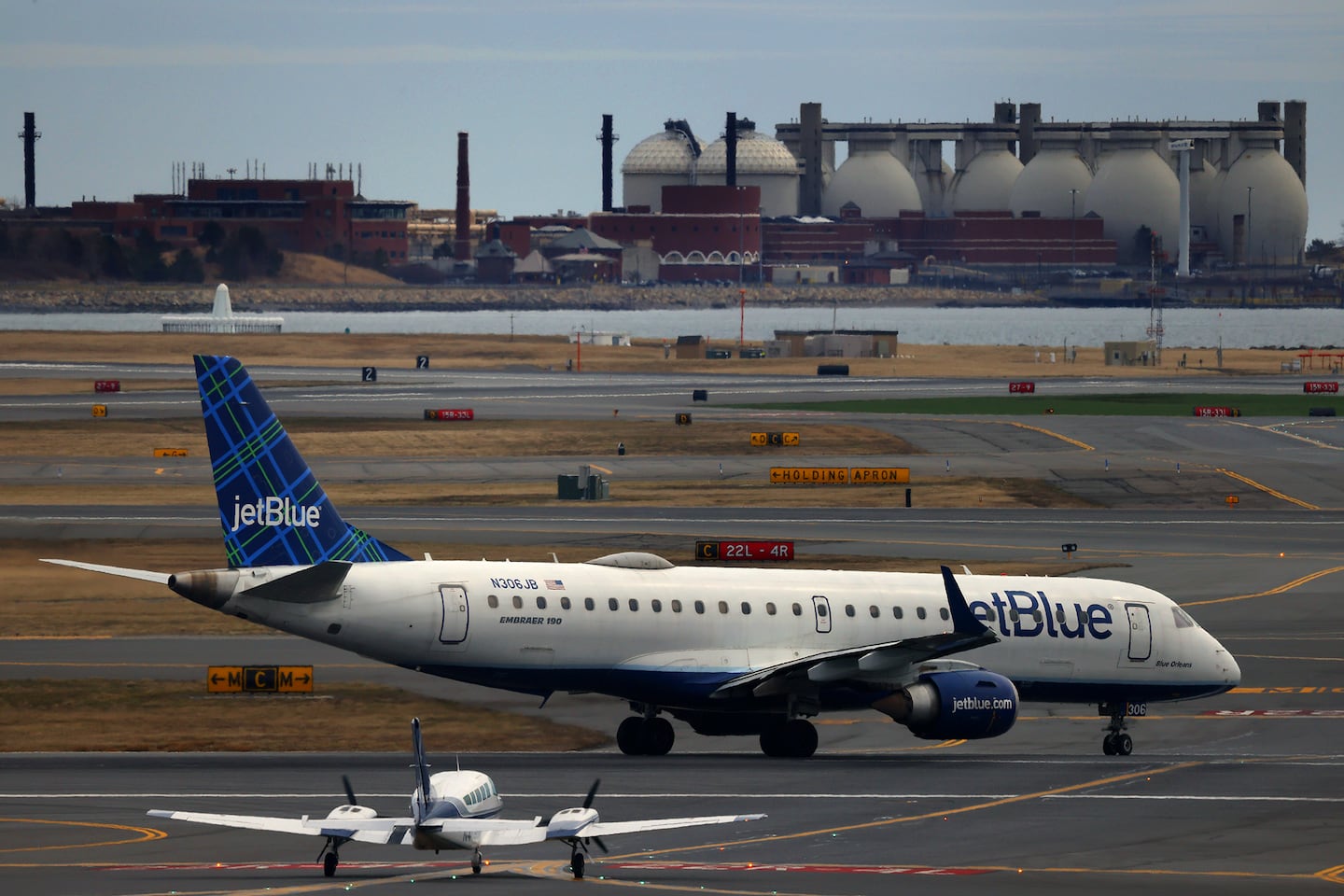 A JetBlue plane taxis on the Logan Airport runway in March 2025.