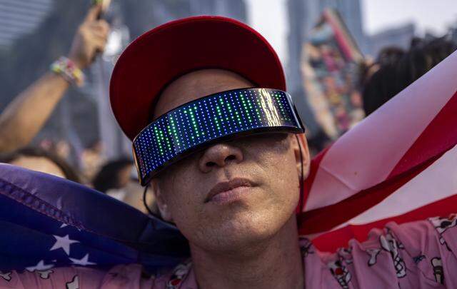 Addel Perez, from Atlanta, holds a flag as Excision performs during Ultra Music Festival’s 26th anniversary at Bayfront Park on Saturday, March 28, 2026, in downtown Miami, Fla.