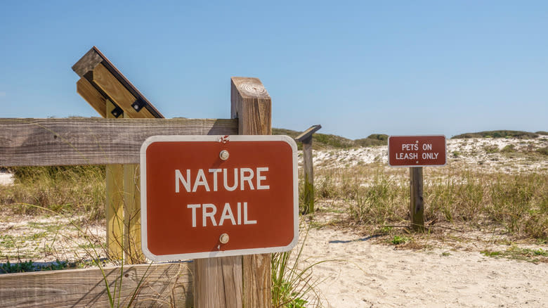 two signs at trailhead, grayton beach state park, florida