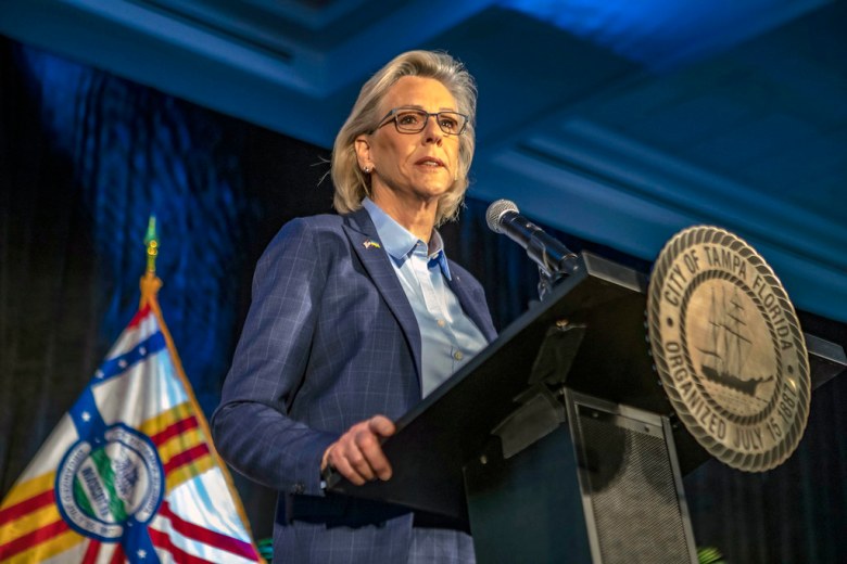 Tampa Mayor Jane Castor speaking at a podium during the State of the City address, featuring the City of Tampa official seal and Florida flag.