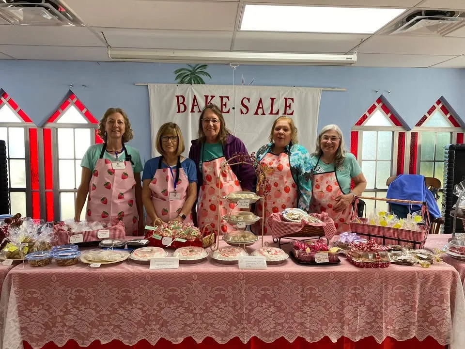 Bake sale workers offer their wares. From left, Jackie Hamblett, Leslie Matkowski, TyAnn Downing, Susan Mahan and Dana Christensen