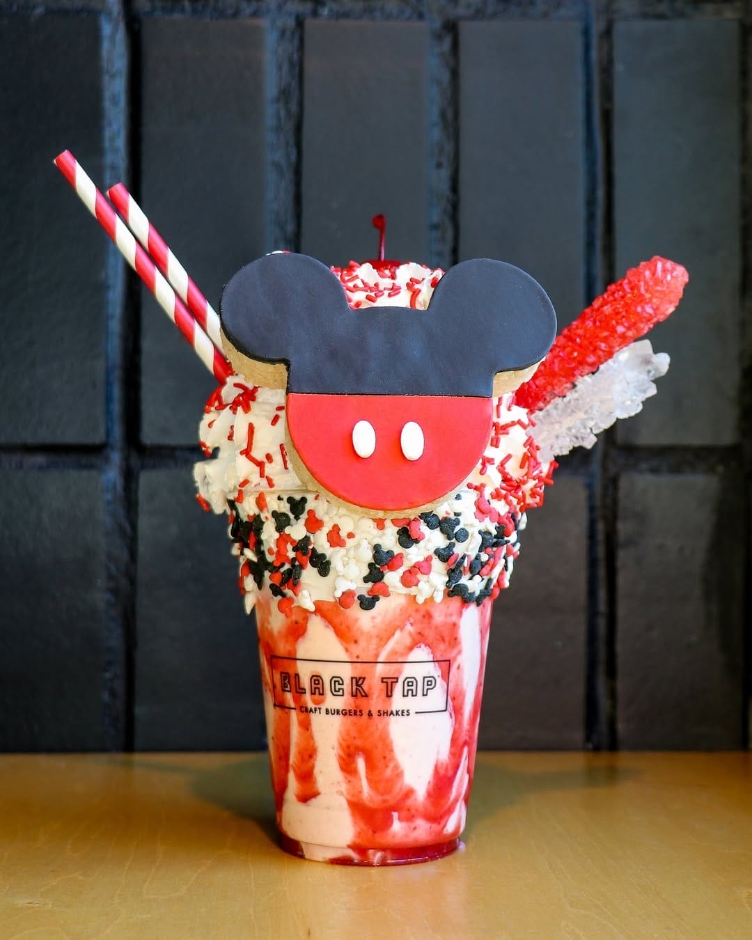 CrazyShake serves Instagrammable shakes, including the Special Edition Mickey Mouse Shake — rimmed with vanilla frosting, Mickey sprinkles, and topped with a homemade Mickey-shaped crispy treat, rock candy, whipped cream, and a cherry. See the full menu below: