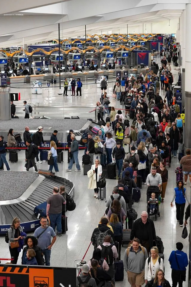 Travelers wait in long lines at Hartsfield-Jackson Atlanta International Airport on March 16, 2026Credit: Megan Varner/Getty