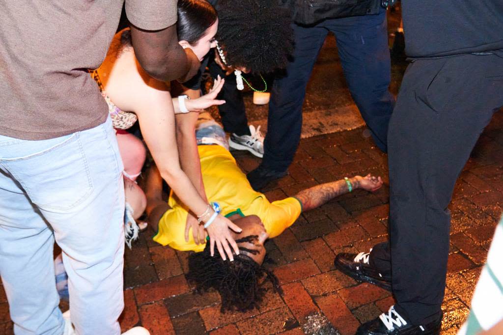 A spring breaker on the sidewalk with others during a night out in Fort Lauderdale, Florida. Romaine Maurice for NY Post