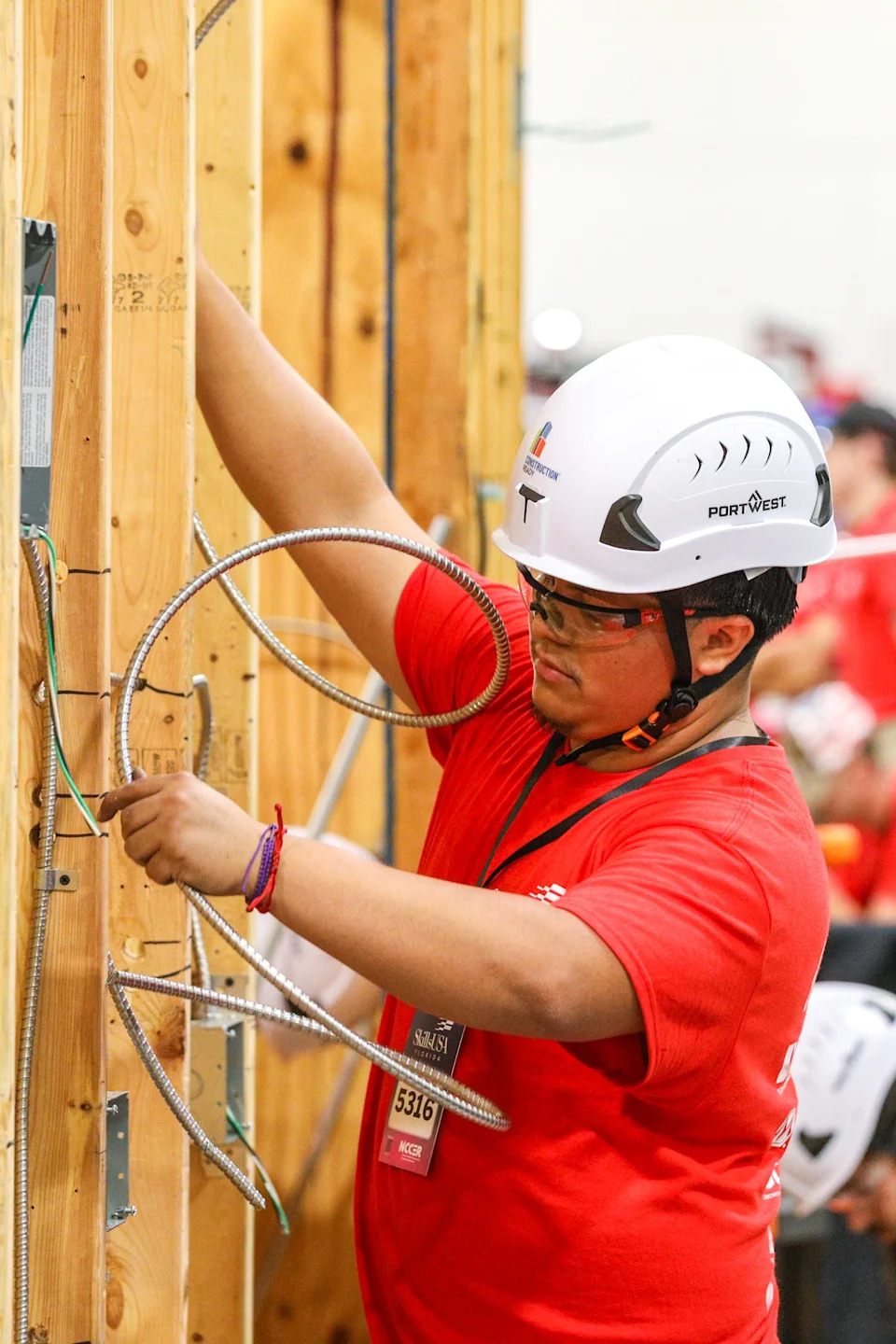 A student handles conduit for electrical lines being placed inside a wall during a skills contest happening alongside the 2025 Construction Ready CareerExpo. The 2026 expo happens March 31 and April 1 at Jacksonville's Prime Osborn Convention Center.
