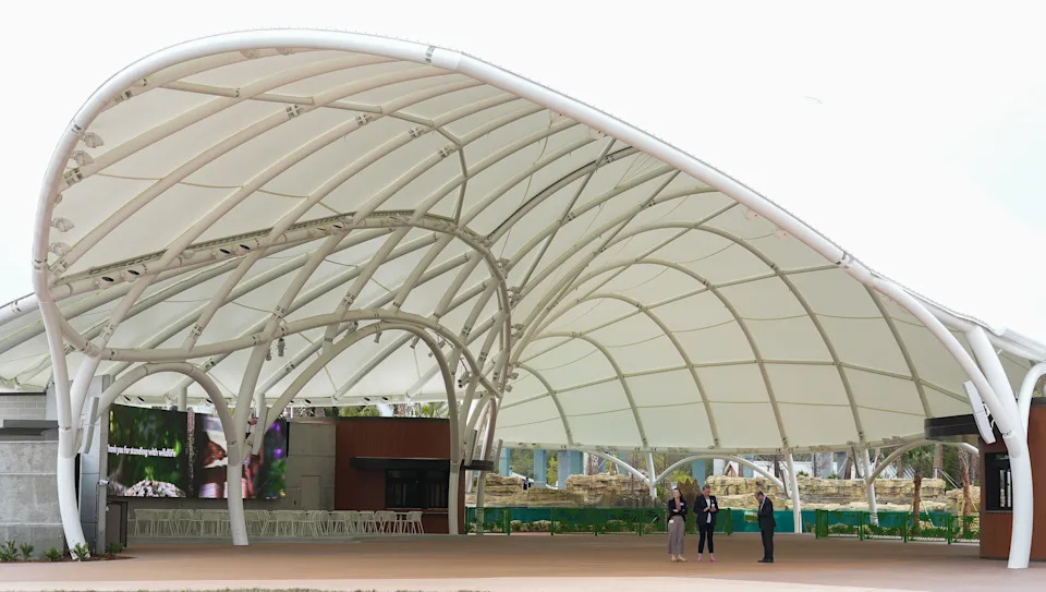 Employees of the Jacksonville Zoo and Botanical Gardens, stand in the entrance to the $72 million J. Wayne and Delores Barr Weaver Manatee River Habitat and VyStar SkyScape Entrance Tuesday March 3, 2026 in Jacksonville, Fla.