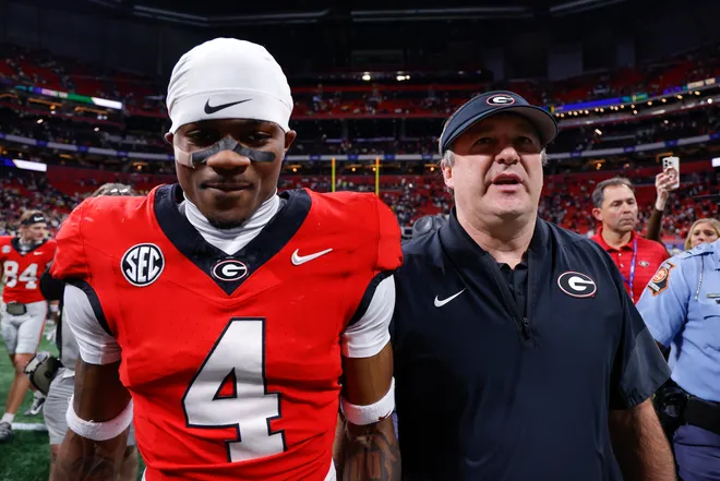 Head coach Kirby Smart of the Georgia Bulldogs reacts with KJ Bolden #4 following the 16-9 victory over the Georgia Tech Yellow Jackets at Mercedes-Benz Stadium