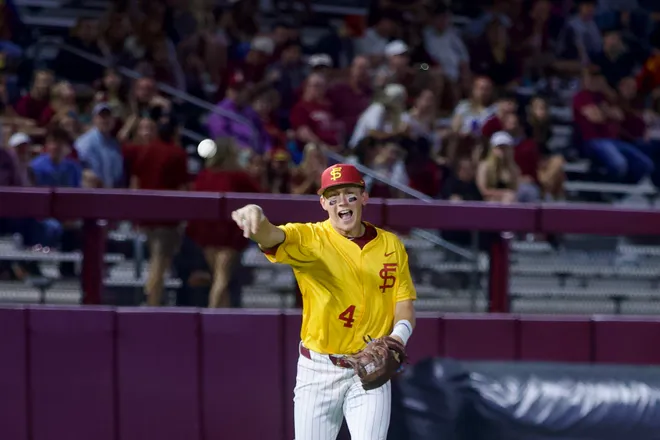 Cal Fisher throws to first base as FSU baseball wore their throwback “mustard” jerseys as the Seminoles hosted Jacksonville on Tuesday, March. 3, 2026 at Dick Howser Stadium