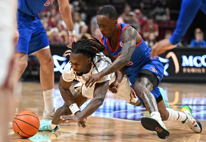 Mar 7, 2026; Tallahassee, Florida, USA; Southern Methodist Mustangs guard Boopie Miller (2) and Florida State Seminoles guard Robert McCray (6) dives for a loose ball during the second half at Donald L. Tucker Center. Mandatory Credit: Melina Myers-Imagn Images