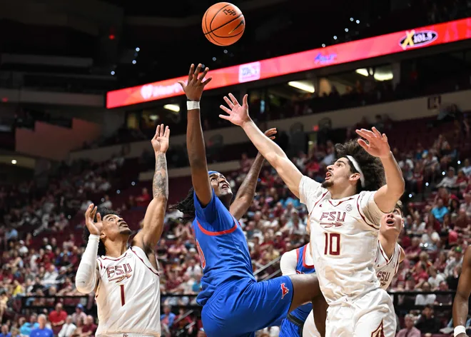 Mar 7, 2026; Tallahassee, Florida, USA; Southern Methodist Mustangs center Jaden Toombs (10) goes up for a rebound against Florida State Seminoles guard Martin Somerville (1) and guard Lajae Jones (10) during the first half at Donald L. Tucker Center. Mandatory Credit: Melina Myers-Imagn Images
