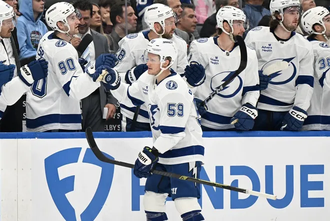 Mar 7, 2026; Toronto, Ontario, CAN; Tampa Bay Lightning forward Jake Guentzel (59) celebrates with teammates at the bench after scoring a goal against the Toronto Maple Leafs in the first period at Scotiabank Arena.