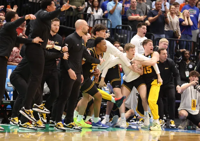 The Iowa bench erupts after a last second three pointer put them in the lead during the second half of the NCAA March Madness second round at Benchmark international Arena in Tampa, FL on Friday, March 20, 2026. Florida lost 73-72 [Alan Youngblood/Gainesville Sun]