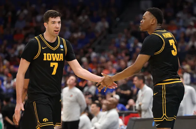 Mar 22, 2026; Tampa, FL, USA; Iowa Hawkeyes forward Alvaro Folgueiras (7) high-fives Iowa Hawkeyes forward Cam Manyawu (3) against the Florida Gators in the second half during a second round game of the men's 2026 NCAA Tournament at Benchmark International Arena. Mandatory Credit: Nathan Ray Seebeck-Imagn Images