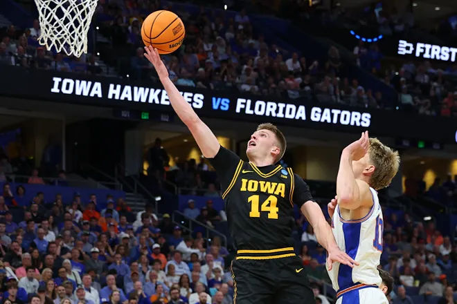 TAMPA, FLORIDA - MARCH 22: Bennett Stirtz #14 of the Iowa Hawkeyes shoots the ball against Thomas Haugh #10 of the Florida Gators during the first half in the second round of the 2026 NCAA Men's Basketball Tournament at Benchmark International Arena on March 22, 2026 in Tampa, Florida. (Photo by Mike Carlson/Getty Images)