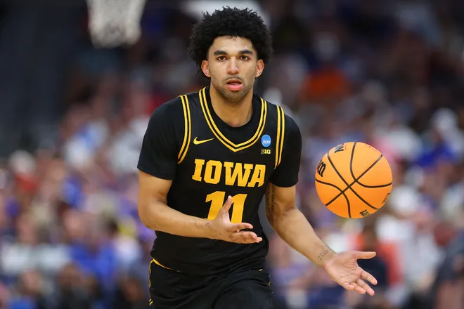 TAMPA, FLORIDA - MARCH 22: Kael Combs #11 of the Iowa Hawkeyes passes the ball against the Florida Gators during the first half in the second round of the 2026 NCAA Men's Basketball Tournament at Benchmark International Arena on March 22, 2026 in Tampa, Florida. (Photo by Mike Carlson/Getty Images)
