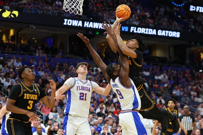 TAMPA, FLORIDA - MARCH 22: Tavion Banks #6 of the Iowa Hawkeyes shoots the ball against Rueben Chinyelu #9 of the Florida Gators during the first half in the second round of the 2026 NCAA Men's Basketball Tournament at Benchmark International Arena on March 22, 2026 in Tampa, Florida. (Photo by Mike Carlson/Getty Images)