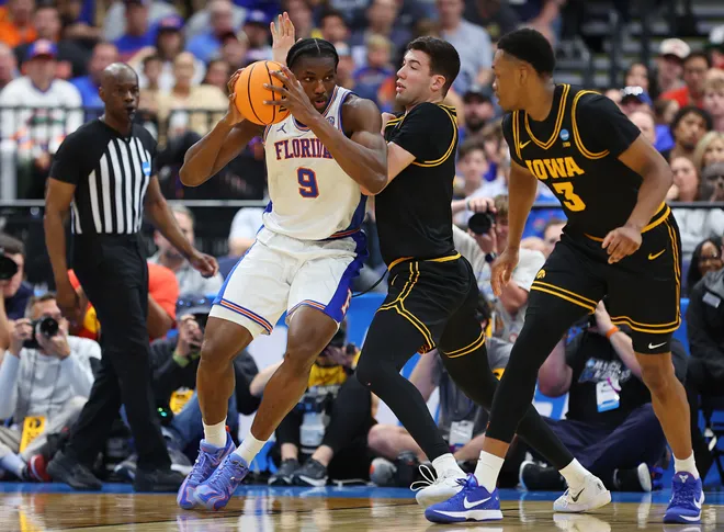 TAMPA, FLORIDA - MARCH 22: Rueben Chinyelu #9 of the Florida Gators looks to shoot the ball against Alvaro Folgueiras #7 of the Iowa Hawkeyes during the first half in the second round of the 2026 NCAA Men's Basketball Tournament at Benchmark International Arena on March 22, 2026 in Tampa, Florida. (Photo by Mike Carlson/Getty Images)
