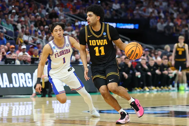 TAMPA, FLORIDA - MARCH 22: Kael Combs #11 of the Iowa Hawkeyes dribbles against Xaivian Lee #1 of the Florida Gators during the first half in the second round of the 2026 NCAA Men's Basketball Tournament at Benchmark International Arena on March 22, 2026 in Tampa, Florida. (Photo by Mike Carlson/Getty Images)