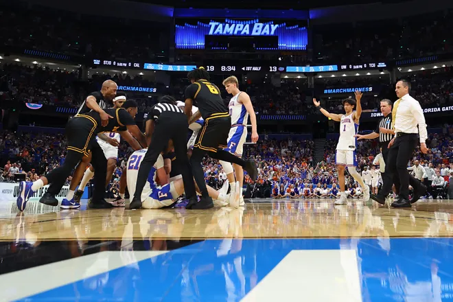 TAMPA, FLORIDA - MARCH 22: Referees intervene as Alex Condon #21 of the Florida Gators and Alvaro Folgueiras #7 of the Iowa Hawkeyes battle for a loose ball during the first half in the second round of the 2026 NCAA Men's Basketball Tournament at Benchmark International Arena on March 22, 2026 in Tampa, Florida. (Photo by Mike Carlson/Getty Images)