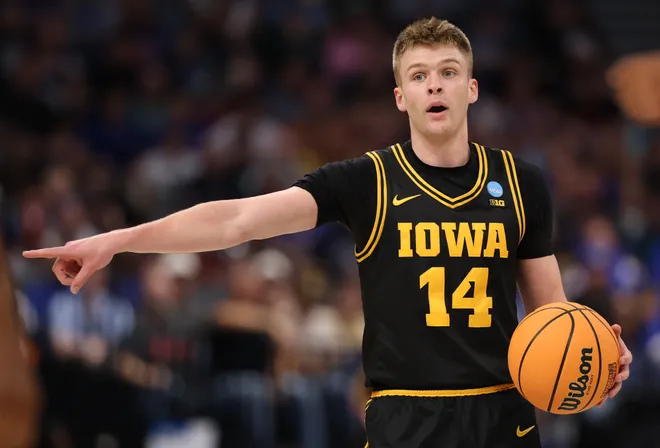 Mar 22, 2026; Tampa, FL, USA; Iowa Hawkeyes guard Bennett Stirtz (14) directs the offense against the Florida Gators in the first half during a second round game of the men's 2026 NCAA Tournament at Benchmark International Arena. Mandatory Credit: Matt Pendleton-Imagn Images
