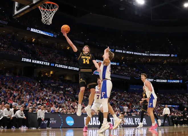 Mar 22, 2026; Tampa, FL, USA; Iowa Hawkeyes guard Bennett Stirtz (14) shoots the ball past Florida Gators forward Thomas Haugh (10) in the first half during a second round game of the men's 2026 NCAA Tournament at Benchmark International Arena. Mandatory Credit: Matt Pendleton-Imagn Images