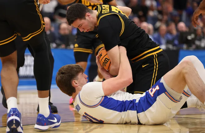 Mar 22, 2026; Tampa, FL, USA; Florida Gators forward Alex Condon (21) and Iowa Hawkeyes forward Alvaro Folgueiras (7) force a jump ball in the first half during a second round game of the men's 2026 NCAA Tournament at Benchmark International Arena. Mandatory Credit: Nathan Ray Seebeck-Imagn Images