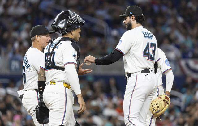 Miami Marlins pitcher Andrew Nardi (43) is substituted by manager Clayton McCullough (86) after pitching against the Colorado Rockies in the eighth inning of their MLB game at loanDepot park on Friday, March 27, 2026, in Miami, Fla.