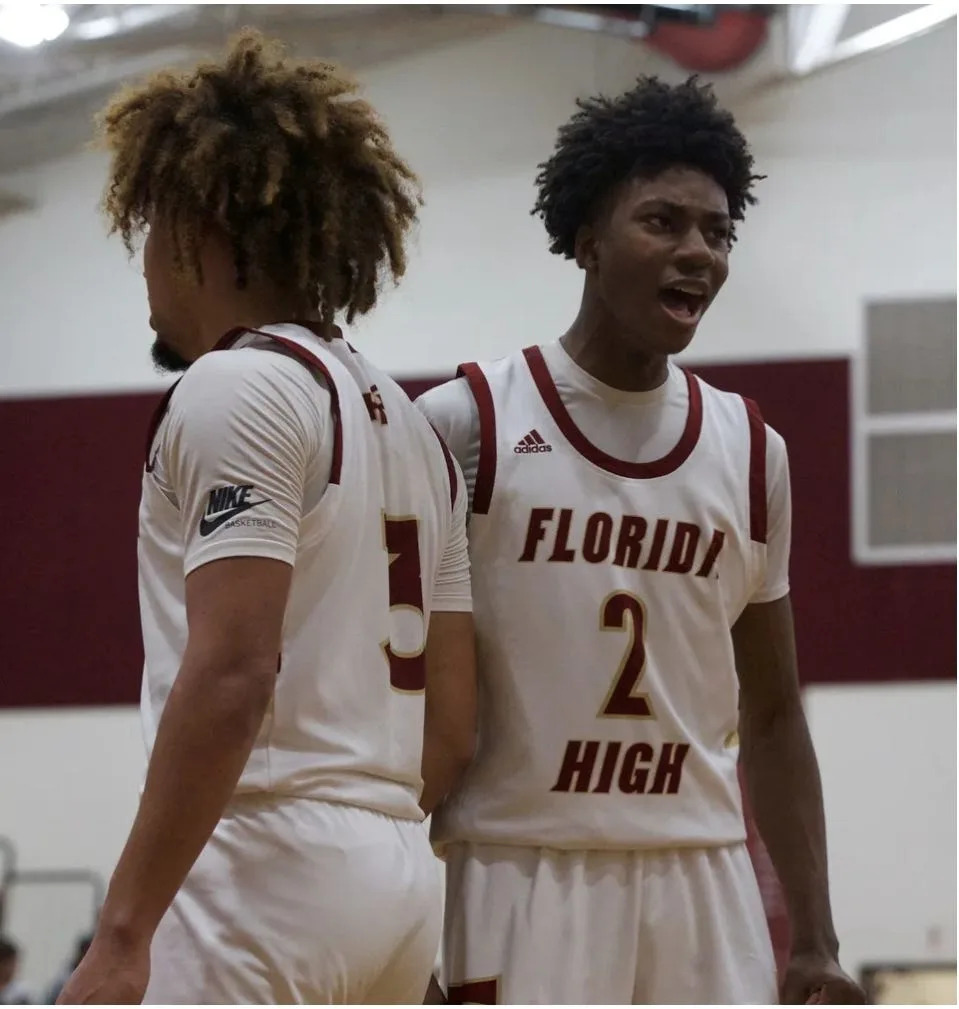 Florida High junior guard Anthony Robinson II (2) celebrates with teammate senior guard Tre Donaldson (3) in Class 3A Region 1 quarterfinals against Maclay on Feb. 17, 2022, at Florida State University School. The Seminoles won, 68-37.