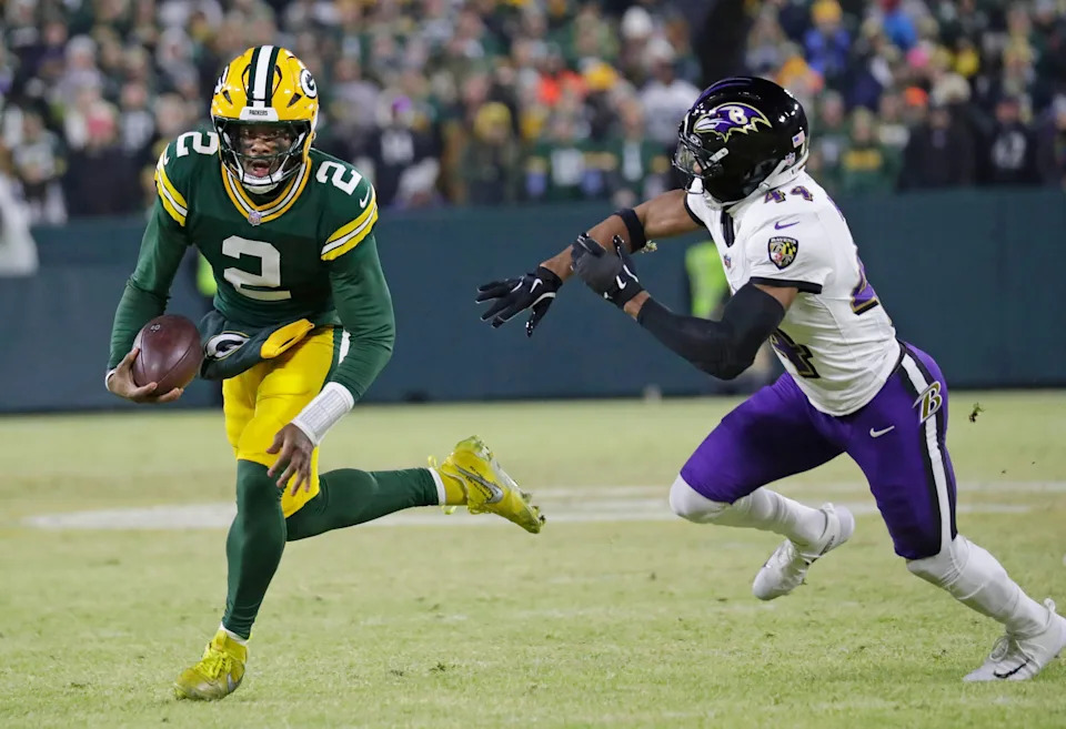 Dec 27, 2025; Green Bay, Wisconsin, USA; Green Bay Packers quarterback Malik Willis (2) breaks away from Baltimore Ravens cornerback Marlon Humphrey (44) to score a touchdown in the second quarter at Lambeau Field in Green Bay, Wisconsin. Mandatory Credit: Dan Powers/USA TODAY NETWORK-Wisconsin