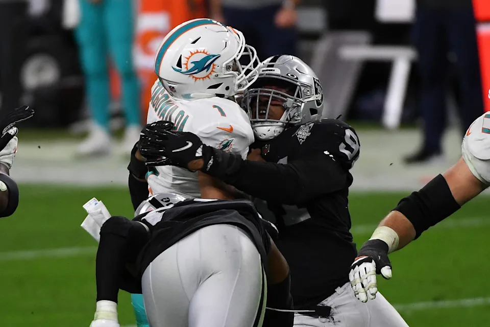 Tua Tagovailoa #1 of the Miami Dolphins is sacked by Kendal Vickers #91 of the Las Vegas Raiders