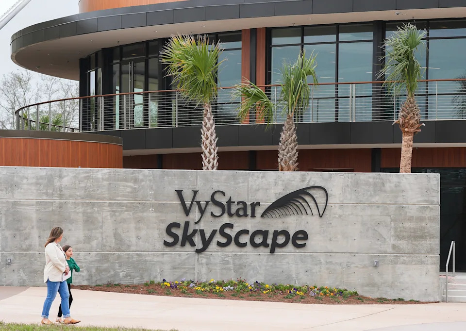 Chloe Dean and her daughter Garden Dean, 8, walks by the entrance to the $72 million J. Wayne and Delores Barr Weaver Manatee River Habitat and VyStar SkyScape Entrance Tuesday March 3, 2026 in Jacksonville, Fla. [Doug Engle/Florida Times-Union]