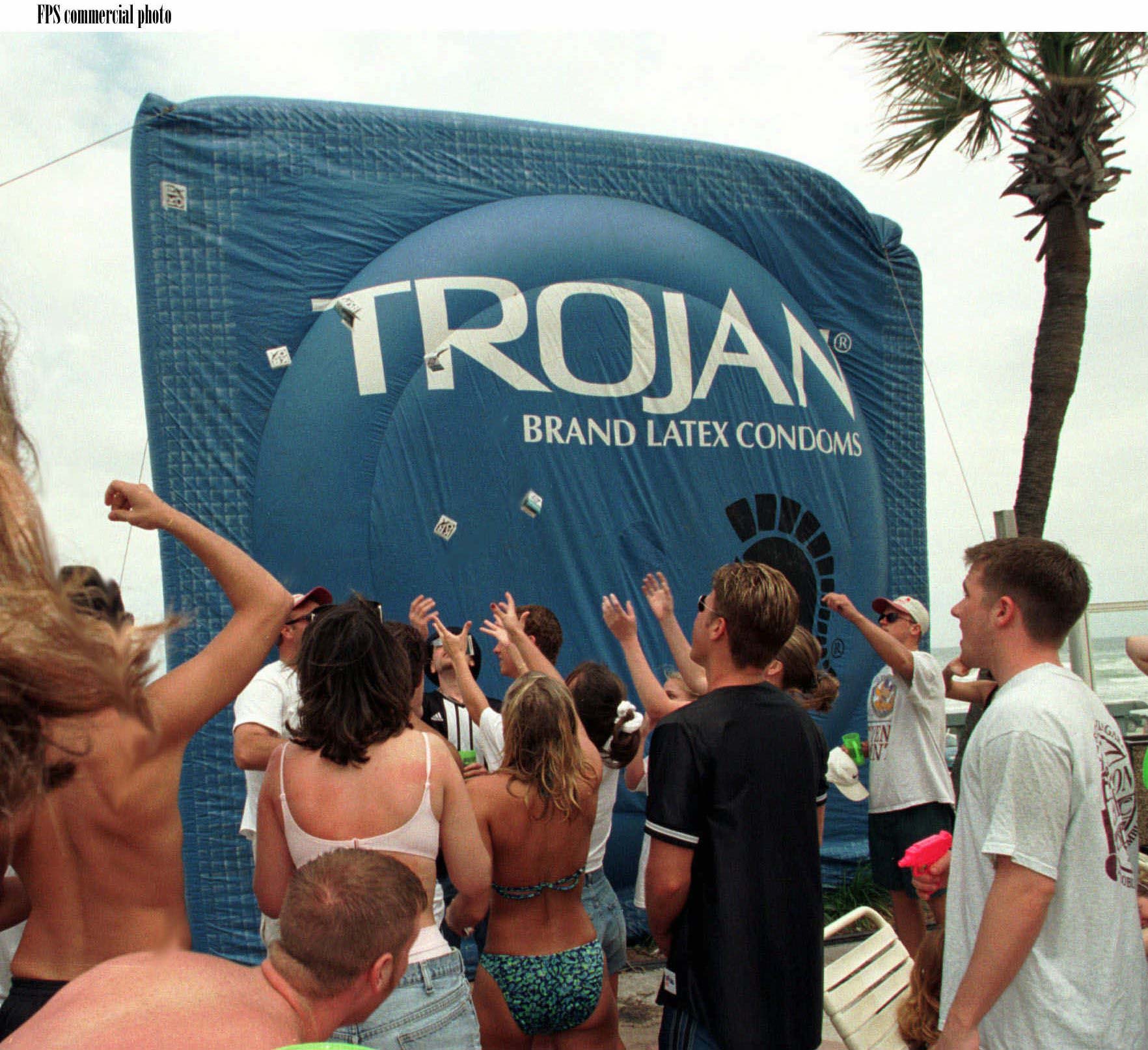 Spring breakers check out a 15-foot inflatable condom package at...