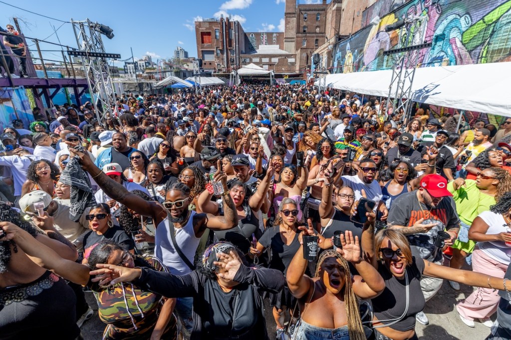 Photo of many people outside dancing during the day