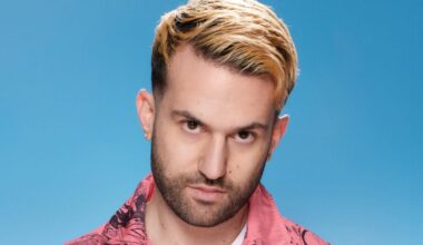 Photo of a man looking at the camera against a light blue background.