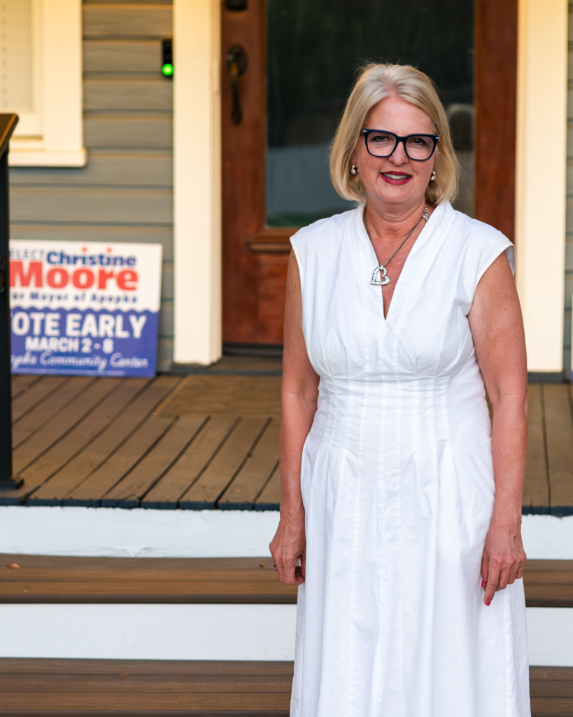 Orange County Commissioner Christine Moore smiles at her March 10 watch party on the front porch of her house.