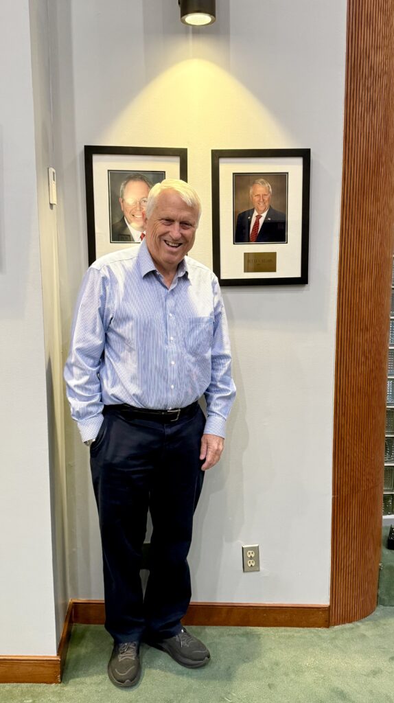 Mayor Bryan Nelson poses with his portrait in City Hall.