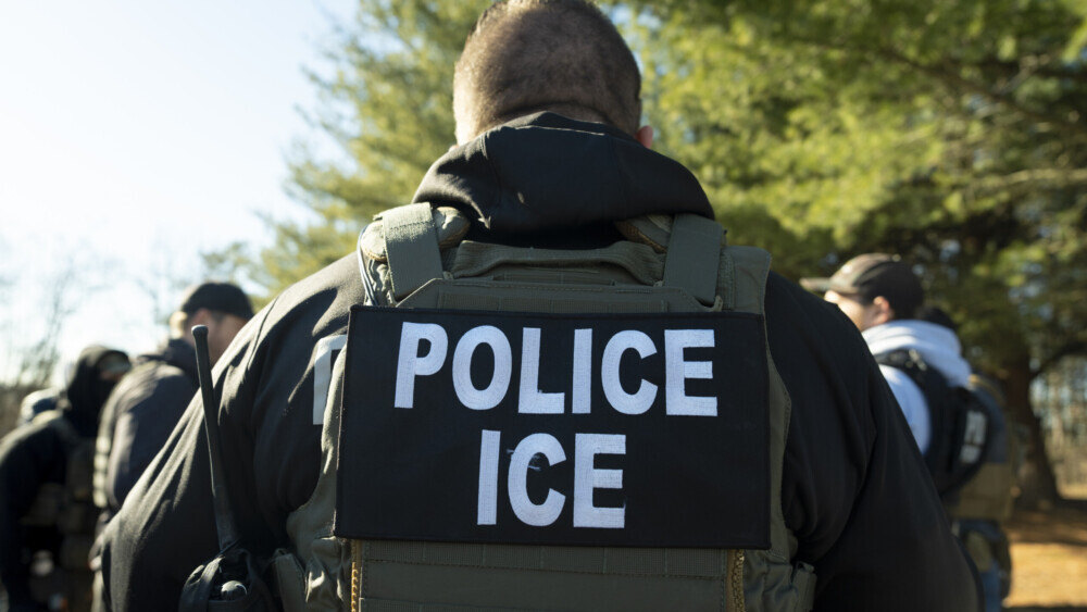 An ICE officer carrying out deportations