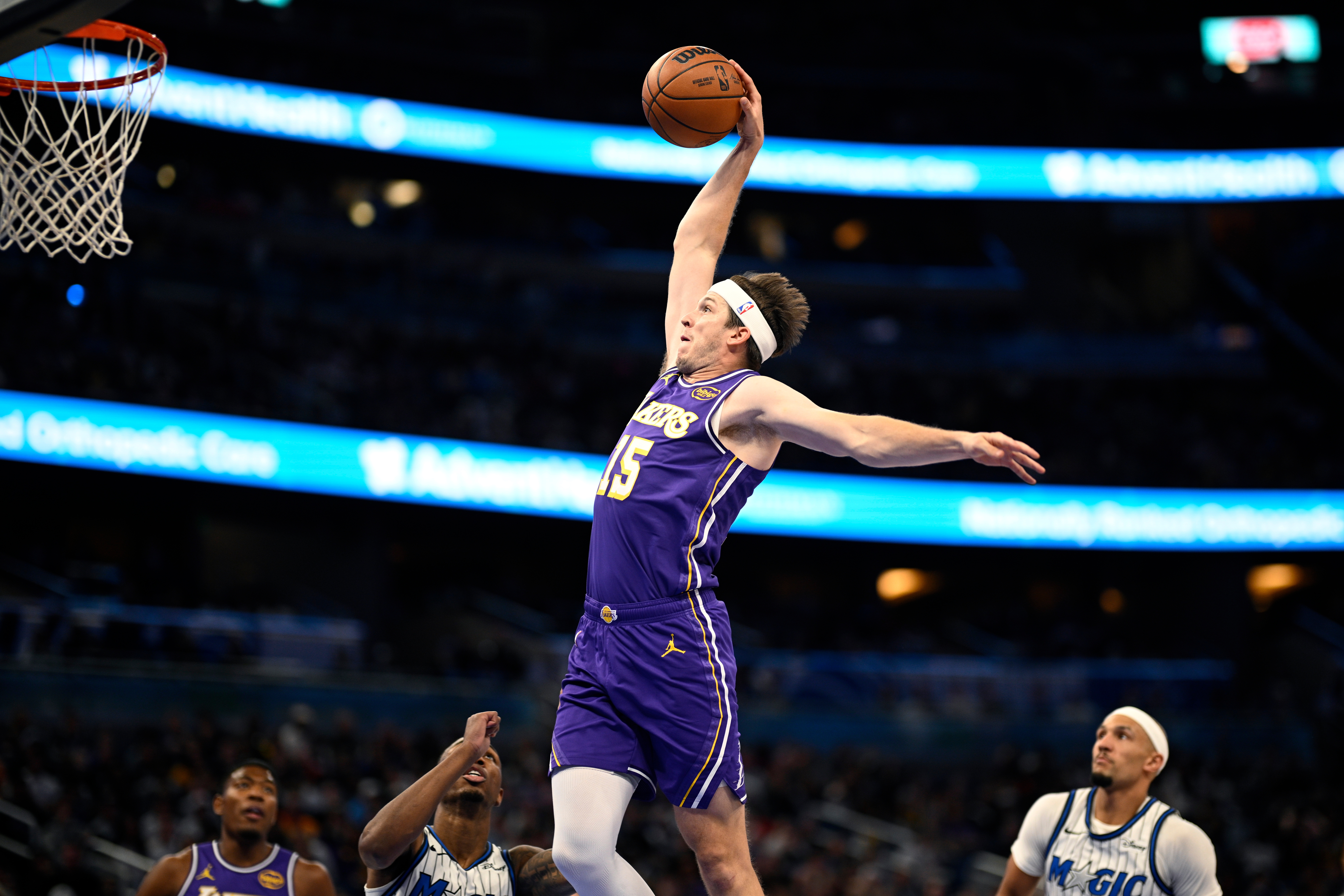 Lakers guard Austin Reaves (15) goes up to dunk between...