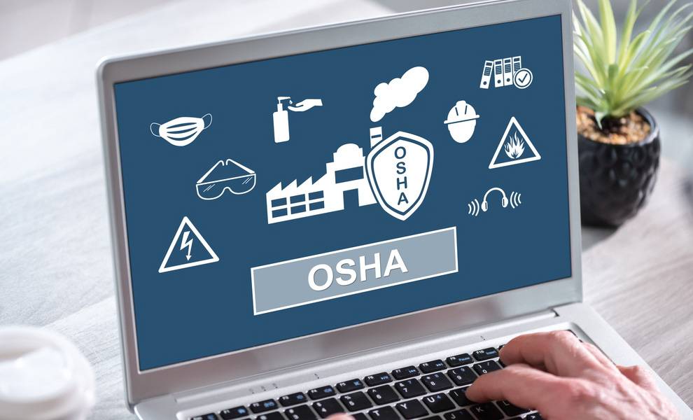 Adonel Concrete: Miami-Based concrete manufacturer cited after fatal workplace incident 2 A laptop screen displays OSHA safety graphics, including icons for a face mask, safety goggles, hand sanitizer, hard hat, hazard symbols, and a factory illustration.
