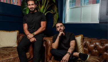 photo of two men sitting on a leather couch